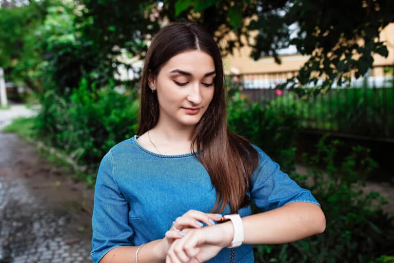 Portrait,Of,Happy,Beautiful,Young,Girl,Smiling,Looking,And,Pointing
